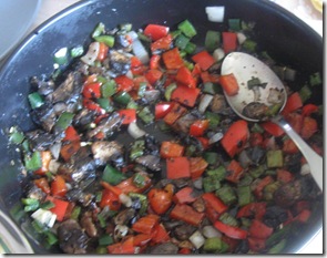 Mushrooms and peppers being cooked