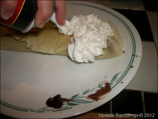 adding lots of whipped cream
