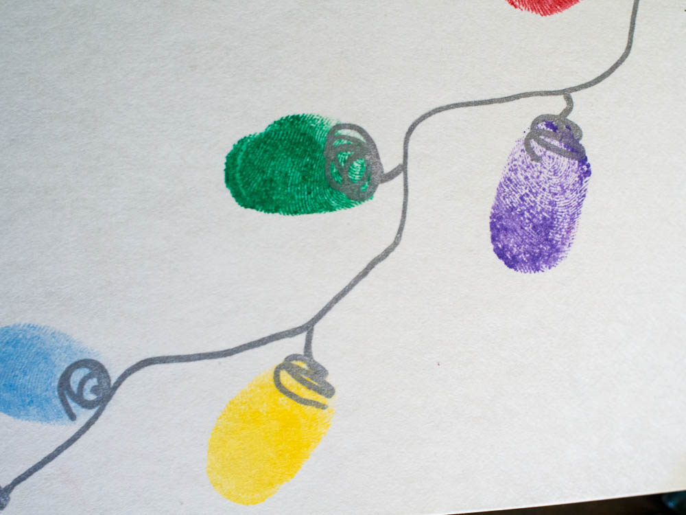 String of Christmas Lights made out of thumbprints - I love these cute Thumbprint Christmas cards! They are so easy to make and a great way to get kids involved in making and sending cards & presents.