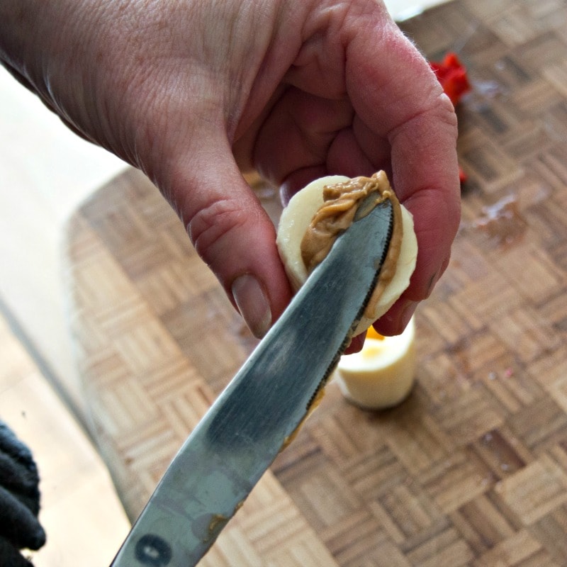 Filling the banana sushi with peanut butter