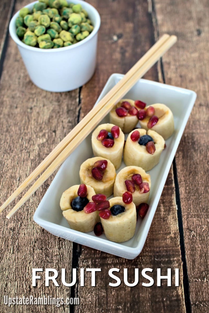 Fruit Sushi - Banana sushi with peanut butter, blueberries and pomegranate and Strawberry Rice Sushi made with Fruitrollups - a kid friendly snack and an easy recipe for kids to make #fruitsushi #snacks #sushi