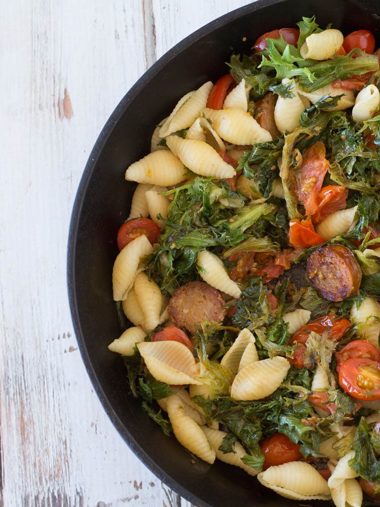 Arugula and Sausage Pasta Skillet - this easy one dish skillet meal combines arugula with Italian sausage, tomatoes and pasta for a delicious and quick weeknight dinner. Arugula Recipes