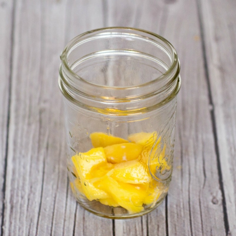 Mango layered in a Mason jar for a healthy Halloween snack