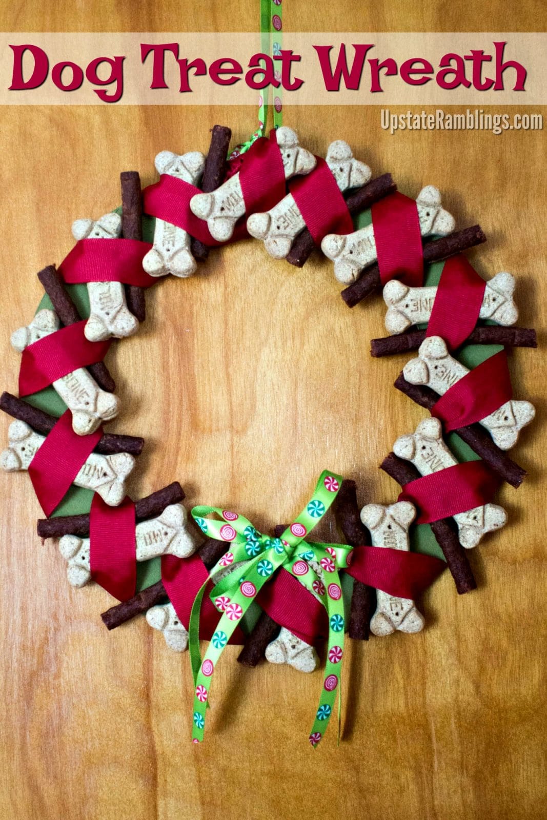 Don't forget your furry friends - celebrate them with a Dog Treat Wreath! This easy to make wreath will have your favorite dog jumping for joy during the holiday season. This makes a perfect holiday decoration - and a great present for your favorite doggie #christmas #dogs #petlover #dogdiy #christmasdecorations