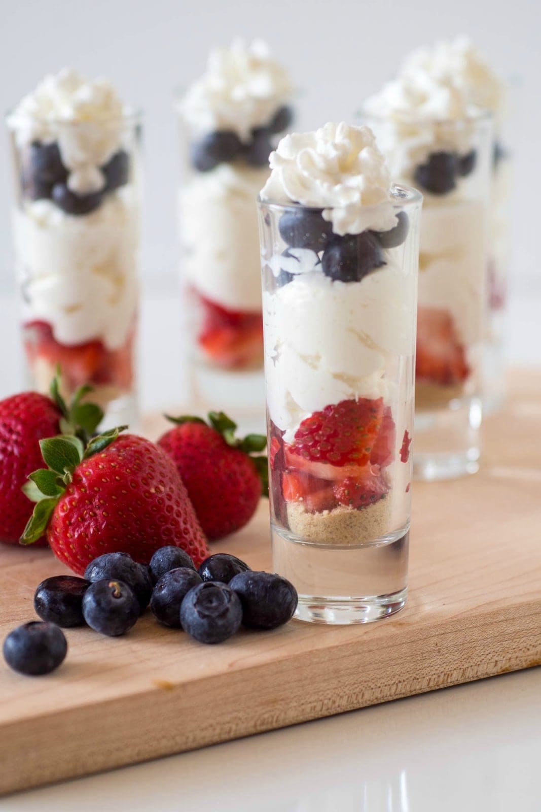 No Bake Patriotic Cheesecake Parfaits - an easy summer time dessert which pairs strawberries, blueberries, and cheesecake for a red, white and blue treat #4thofjuly #patriotic #nobake #cheesecake