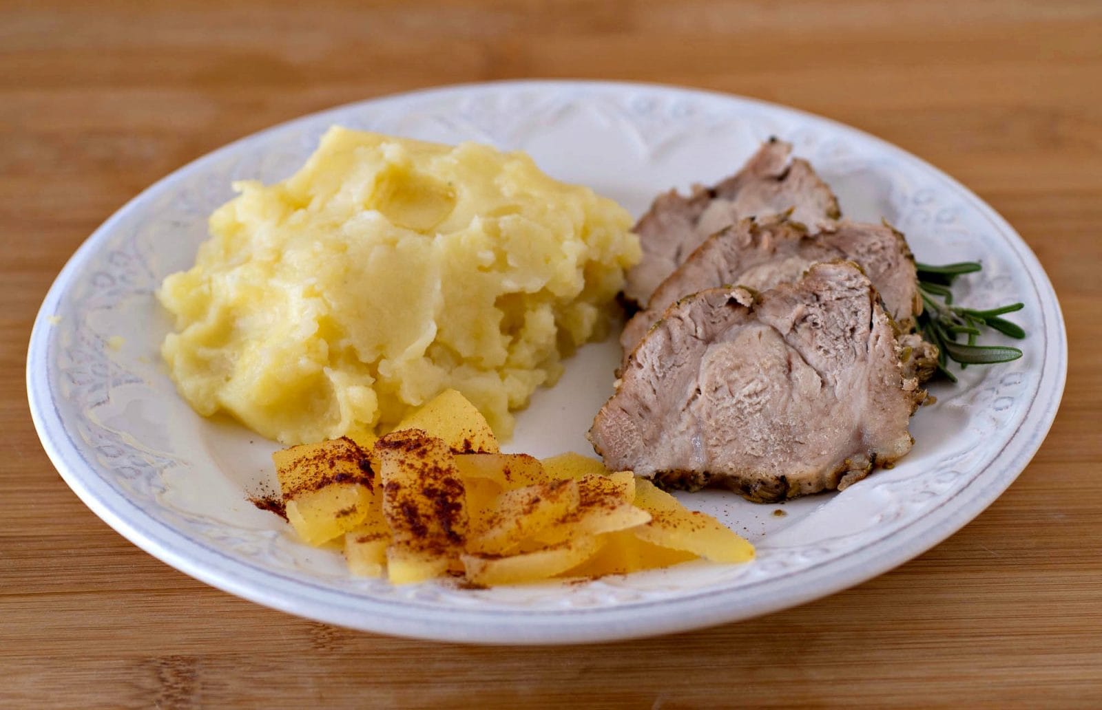 Plate with Instant Pot Pork Loin Recipe with mashed potatoes and apples