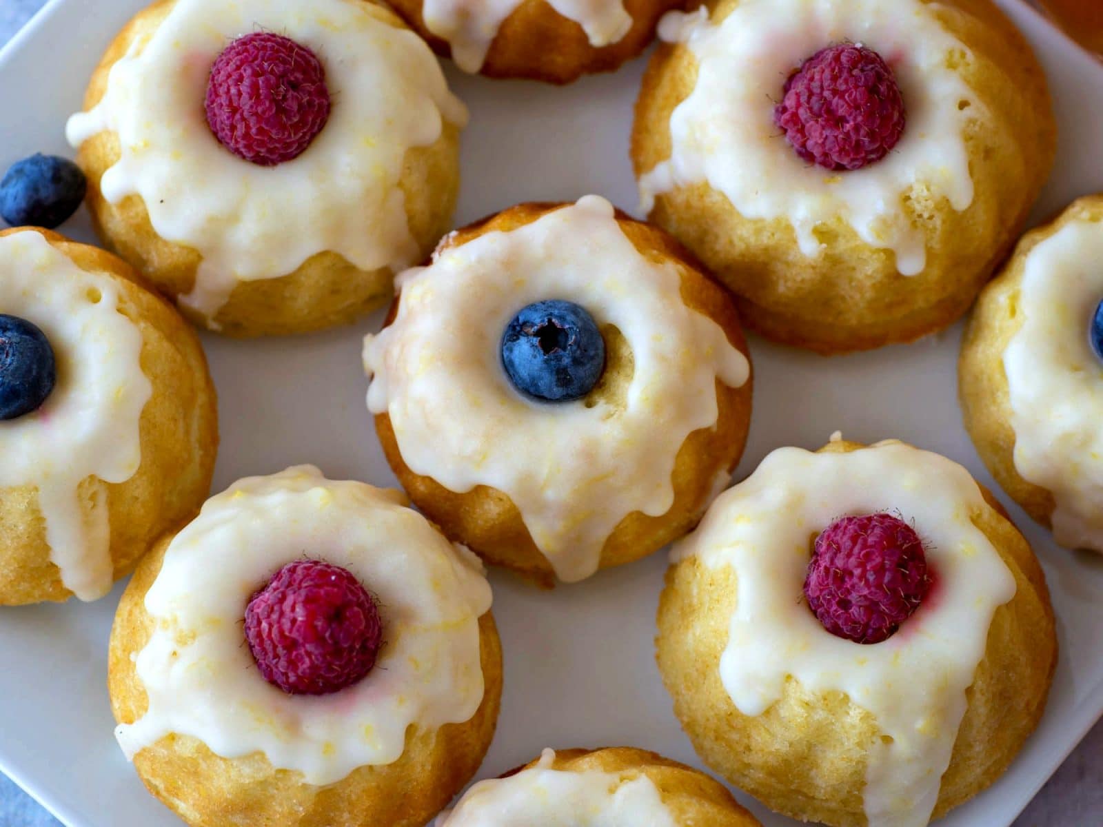 Top view of Lemon Bundt Cakes with raspberries and blueberries