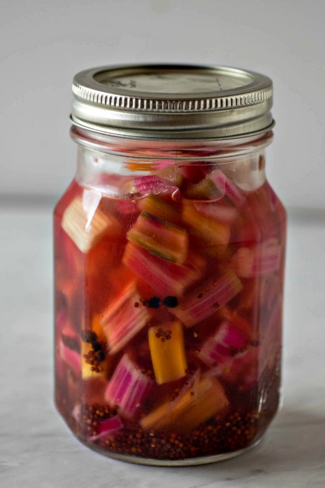 Mason jar with pickled rainbow chard stems