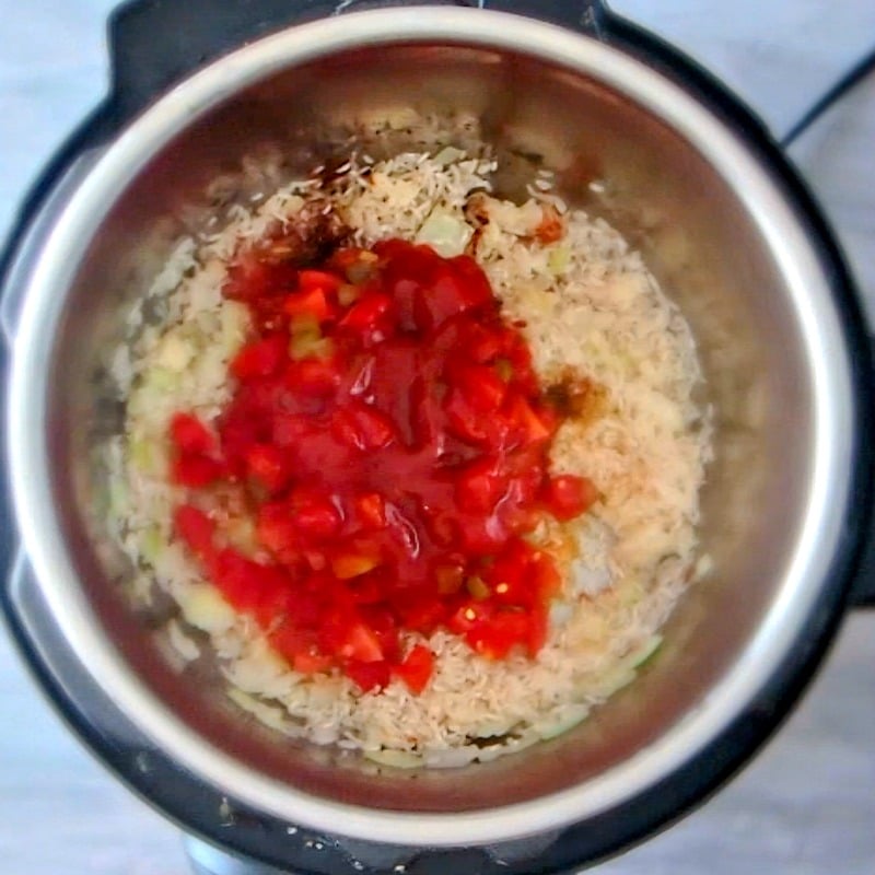 Adding all the ingredients for Instant Pot Mexican Rice