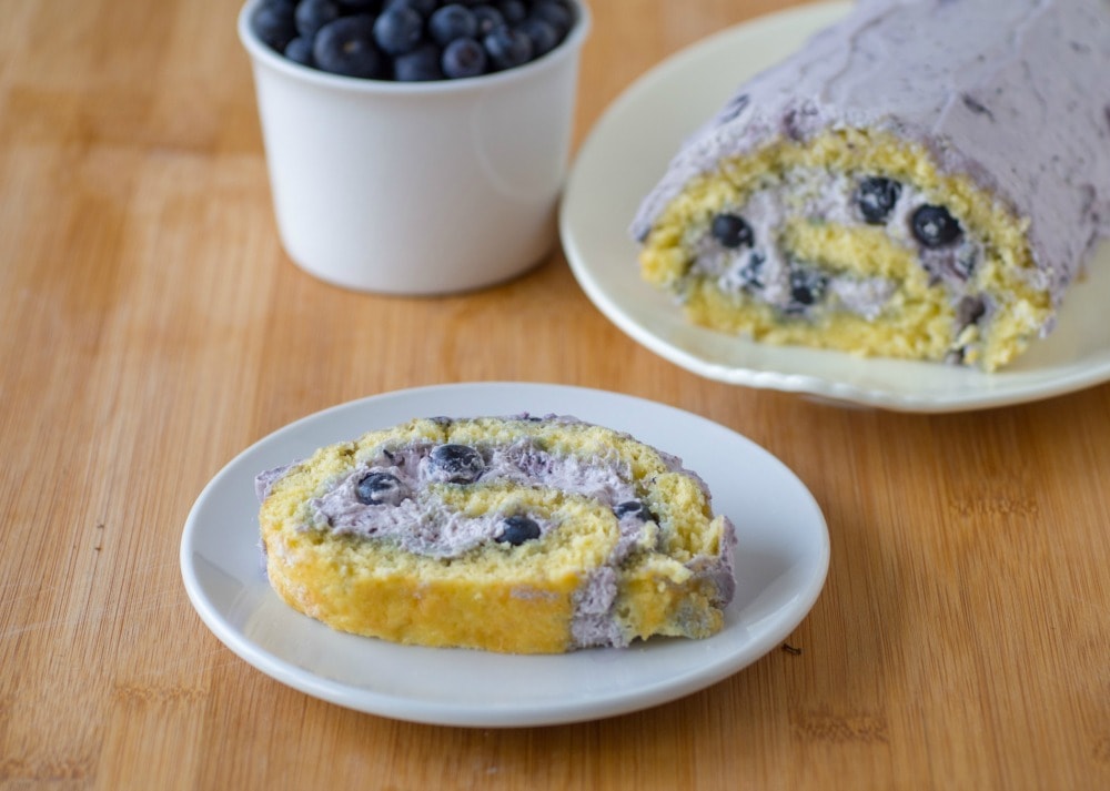 Easy homemade cake roll filled with blueberries and whipped cream