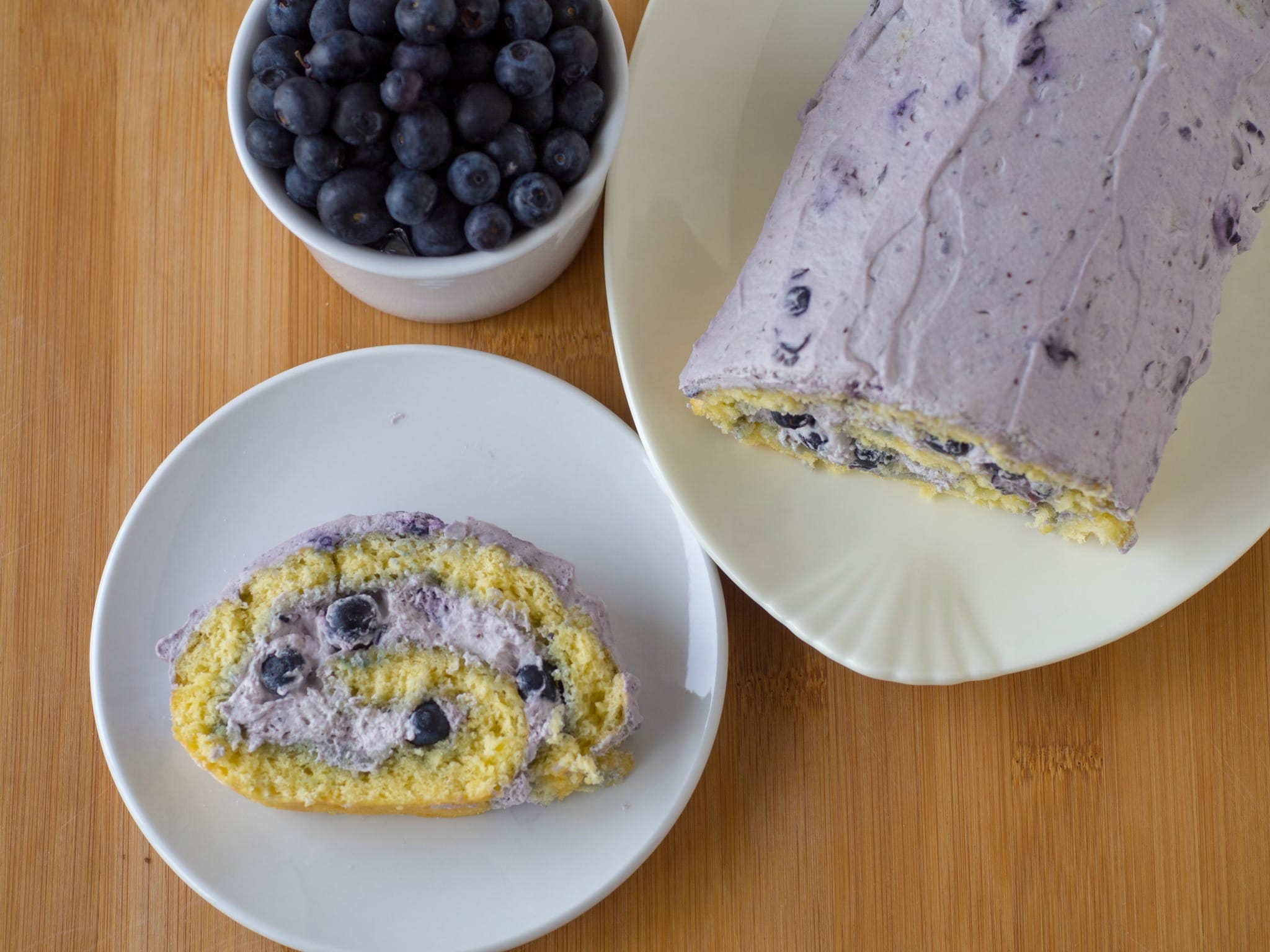 This Blueberry Swiss Roll Cake combines a springy sponge cake rolled up with whipped cream and blueberries. The easy dessert is a delicious way to use blueberries and makes a pretty homemade dessert for the holidays.
