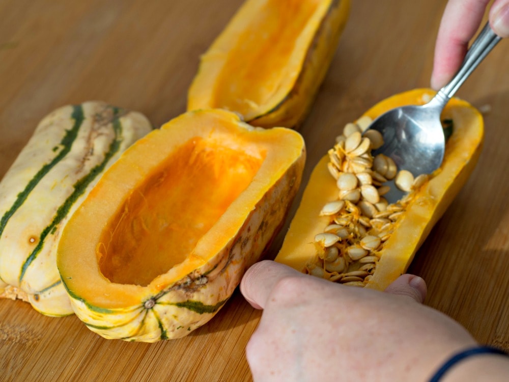 Scooping the seeds out of the delicata squash