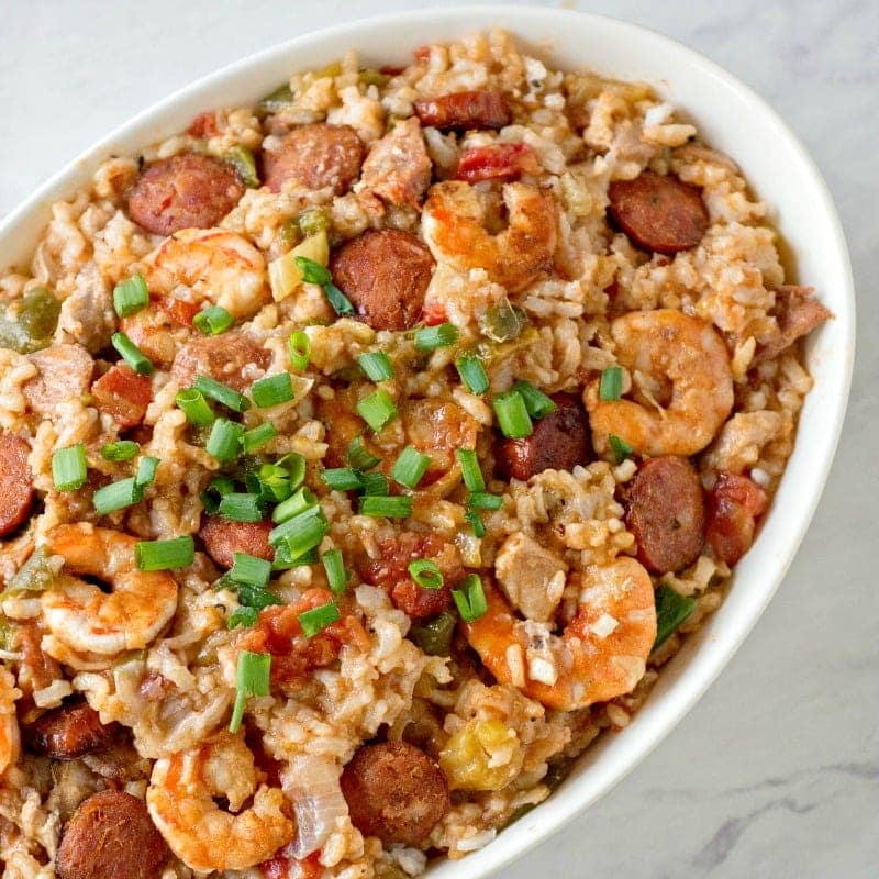 Jambalaya made in the Instant Pot with sausage, shrimp and chicken and green onions scatter on top