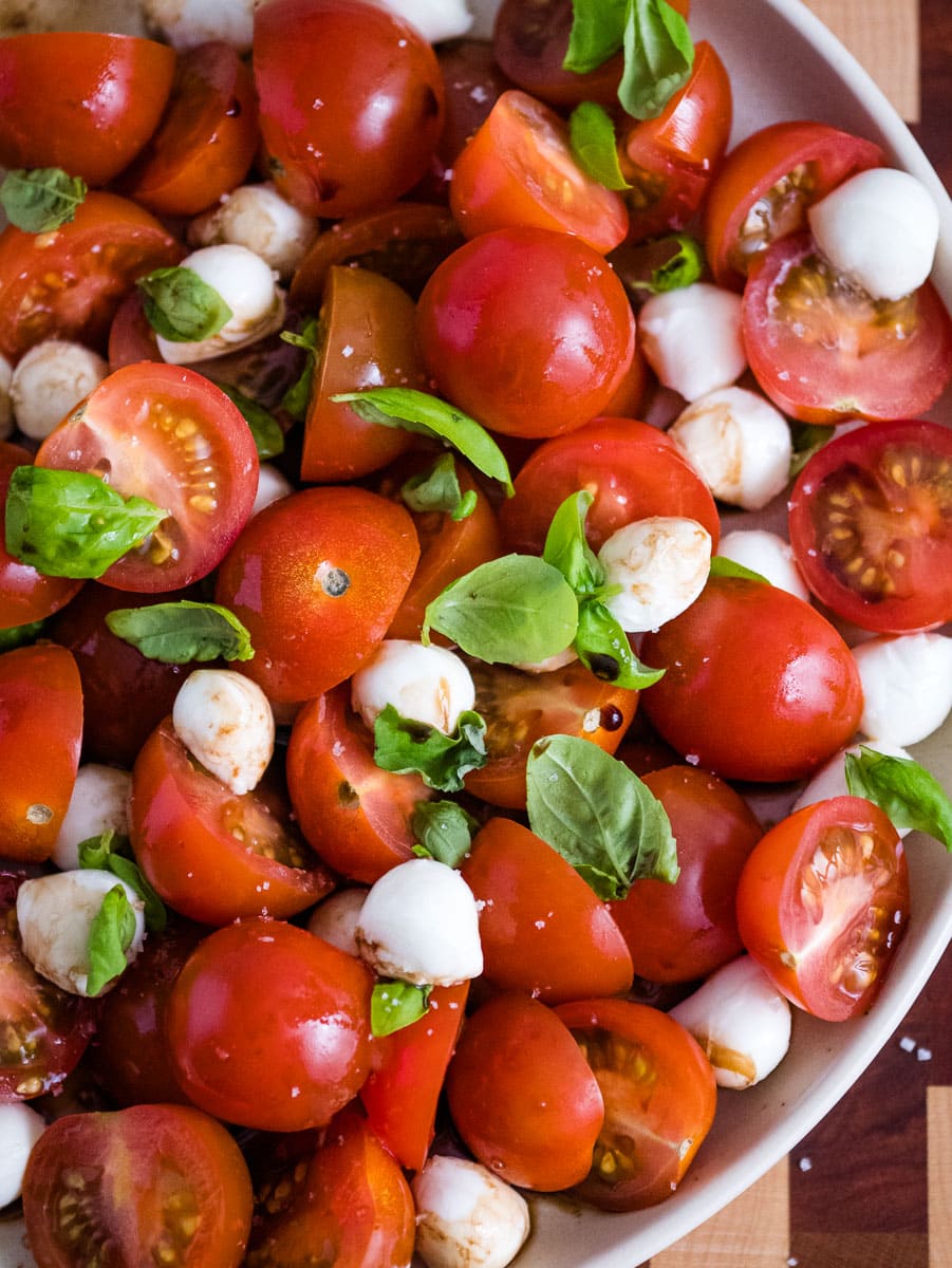 top view of caprese salad with cherry tomatoes on a plate.
