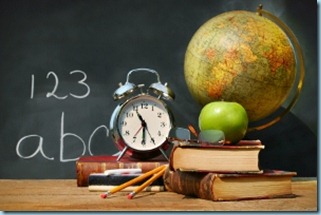 Old school books with a blackboard and a globe