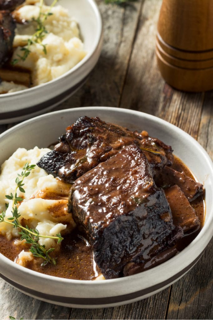 wine braised short ribs in a bowl ready for serving