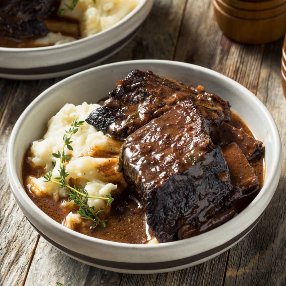 short ribs in a bowl with mashed potatoes