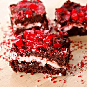 Three pieces of brownies with red sprinkles on top.