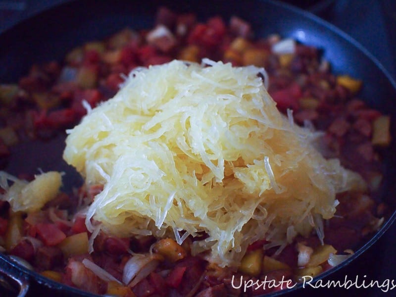 A spicy frying pan filled with stuffed spaghetti squash.