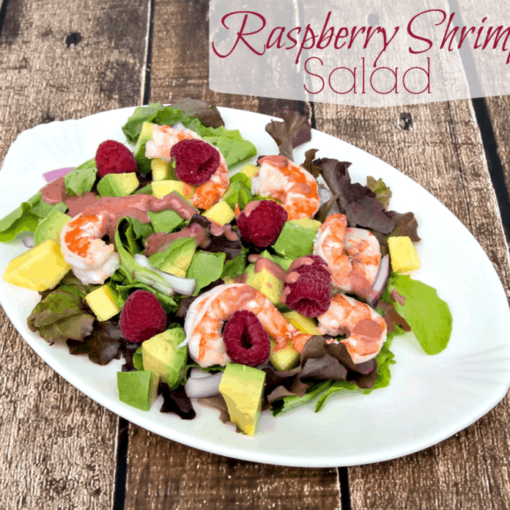 A plate of salad with shrimp and avocado.