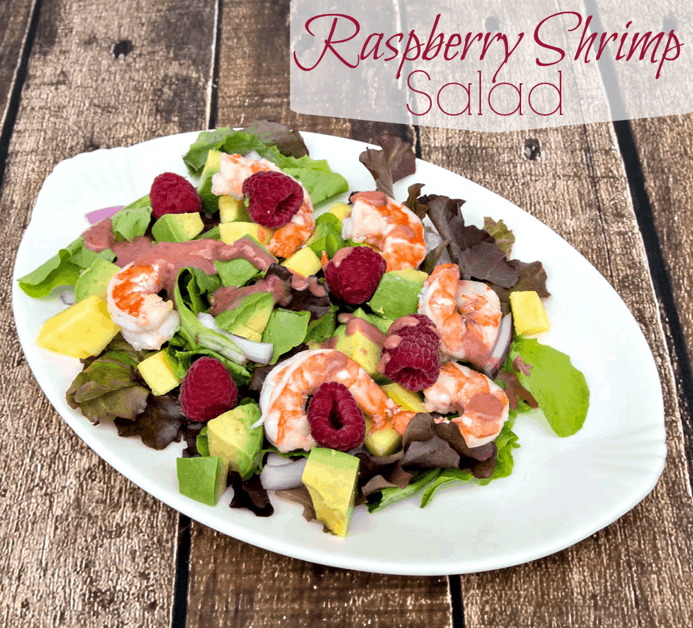 A plate of salad with shrimp and avocado.