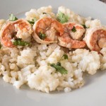A plate with rice and shrimp on it.