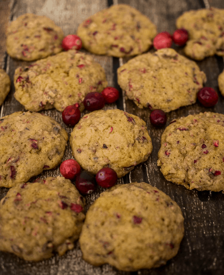 Cranberry chocolate chip cookies on a wooden table.