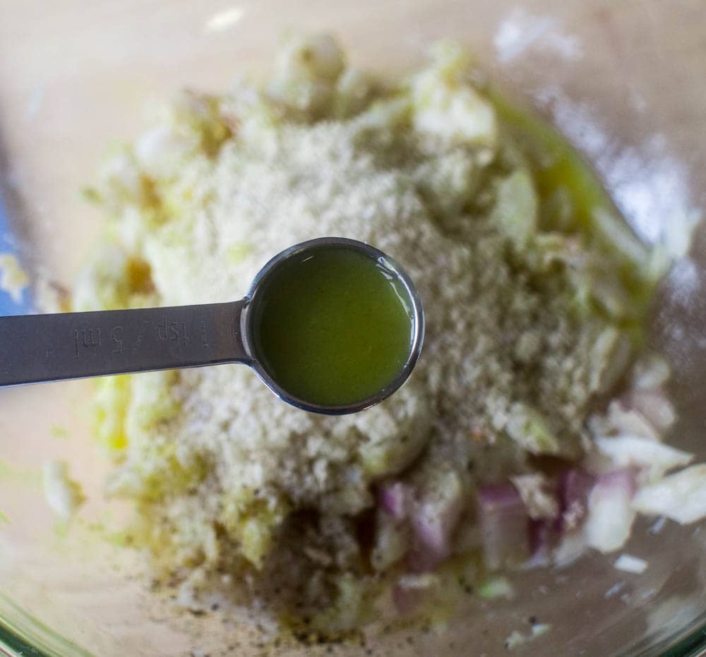 A spoon is being used to stir ingredients in a bowl.