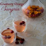 Two glasses of cranberry orange sangria on a table.