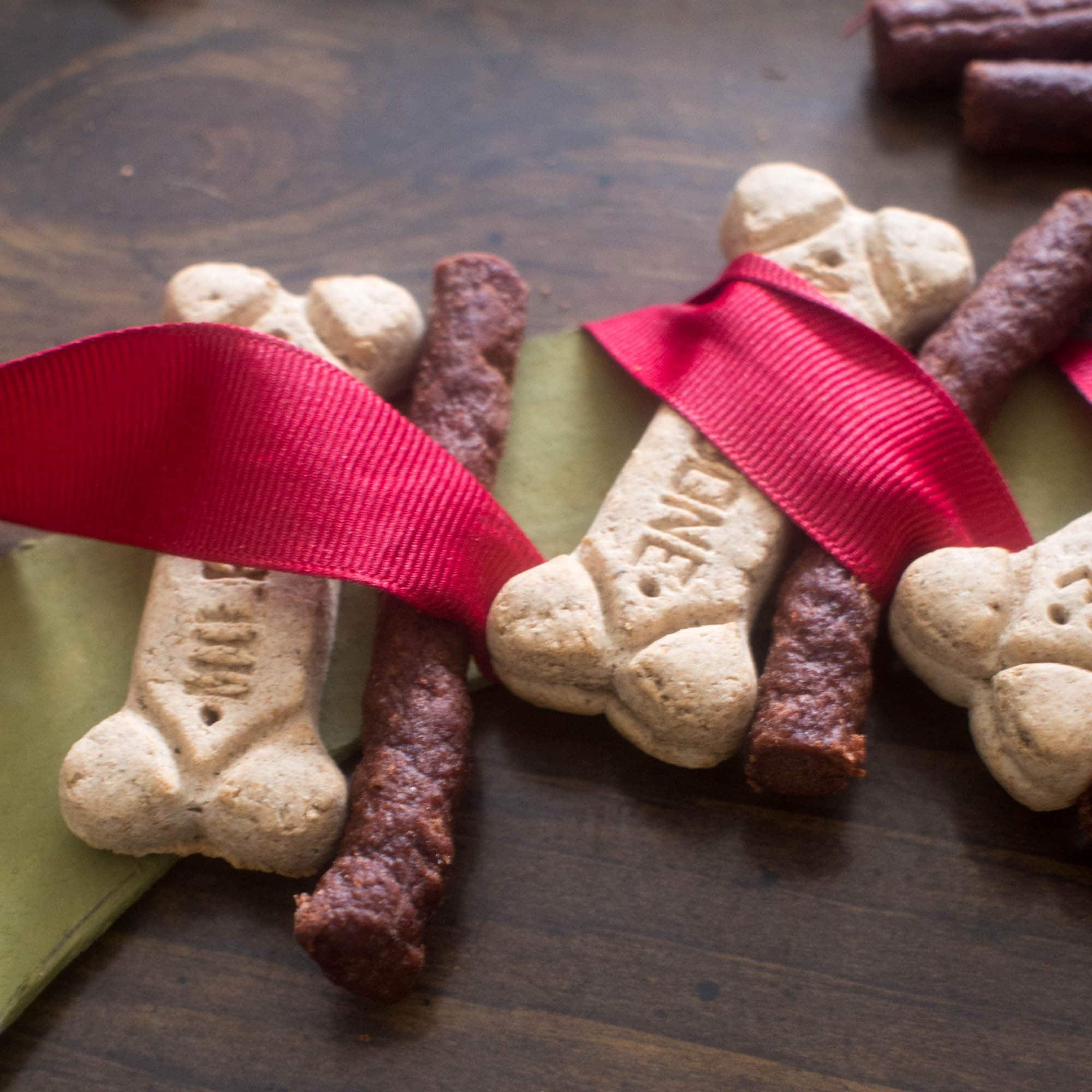 Dog treats with ribbons and bows on a table.