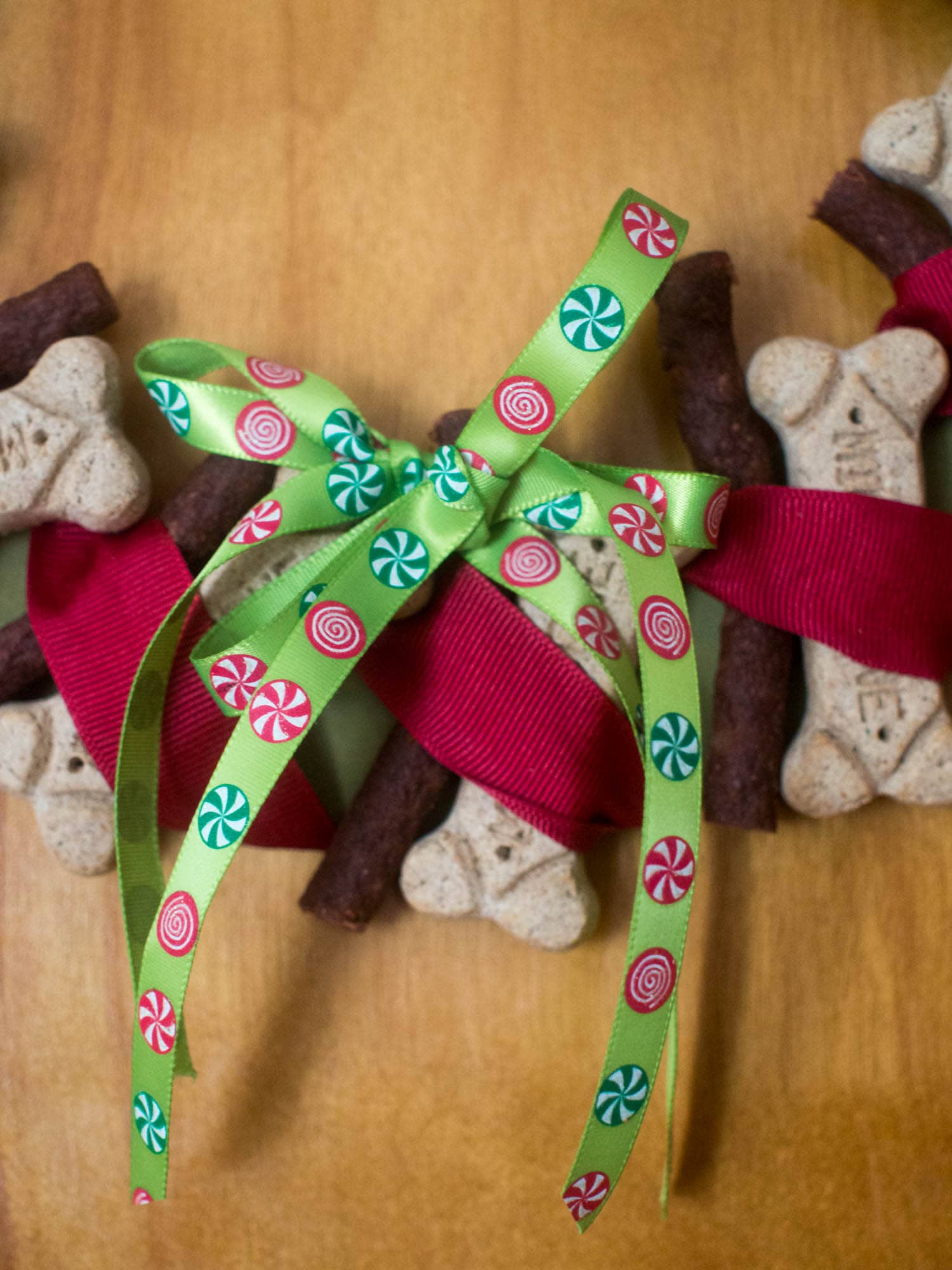 A christmas wreath with candy canes and dog treats.