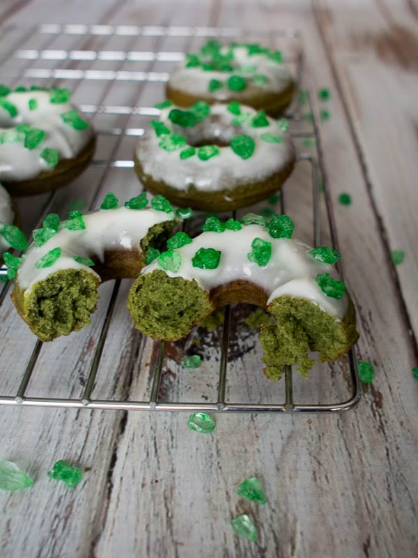 Green donuts on a cooling rack.