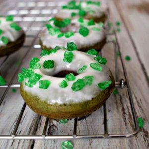 Green donuts with icing and green sprinkles for St. Patrick's Day.