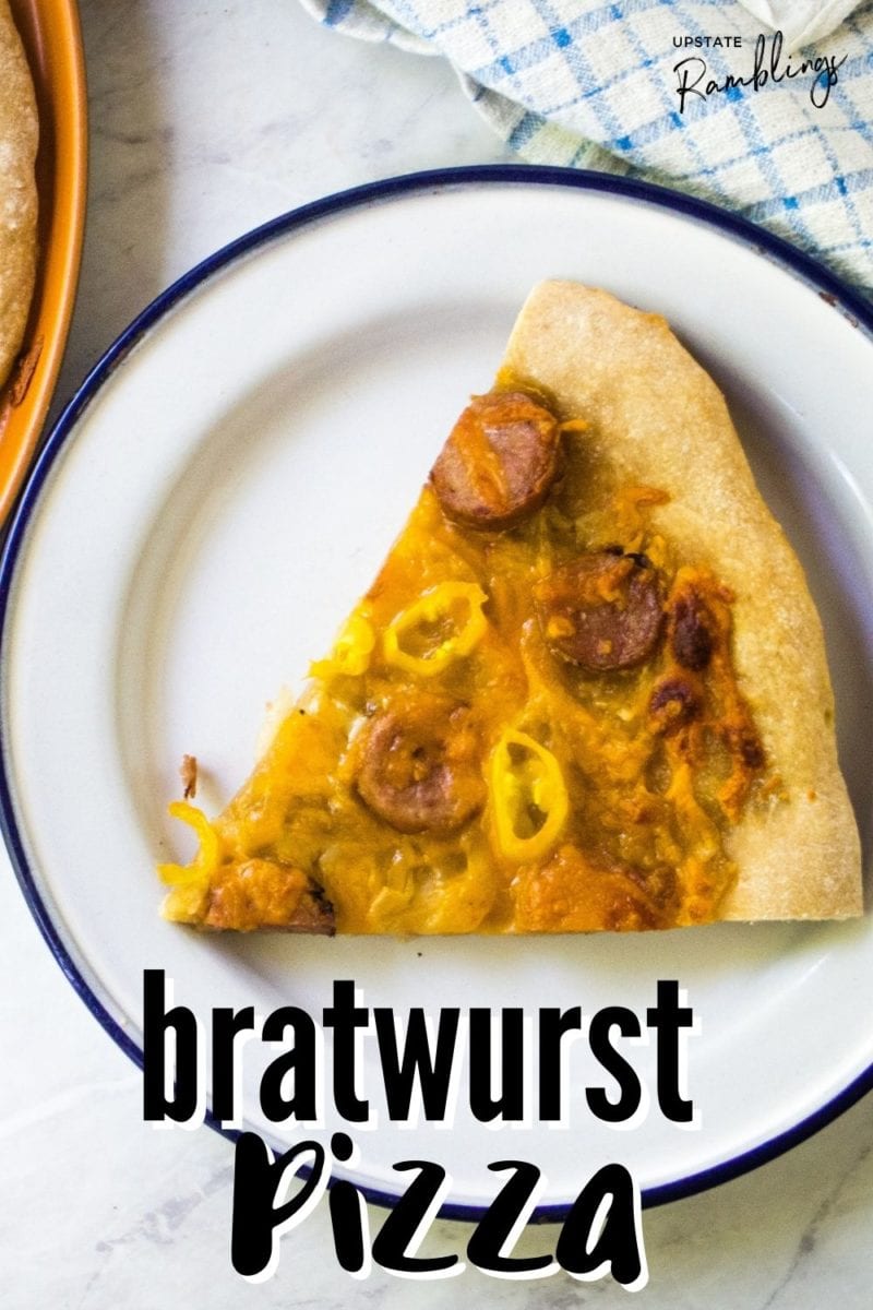 piece of bratwurst pizza on a plate