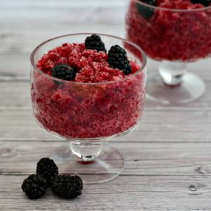 Two bowls of blackberry rhubarb ice cream with blackberries and sangria.