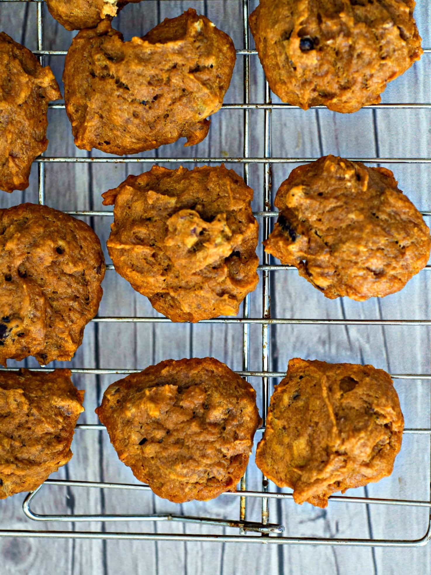 A stack of pumpkin cookies on a cooling rack.