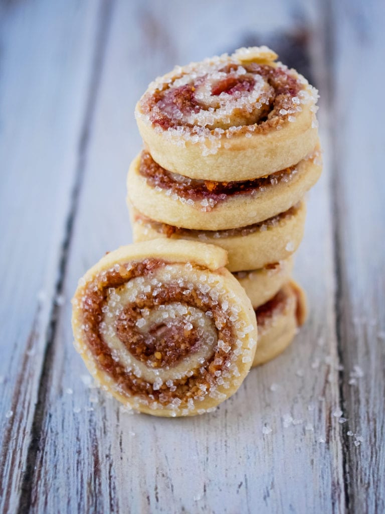 jam pinwheel cookies in a stack with a cookie in front