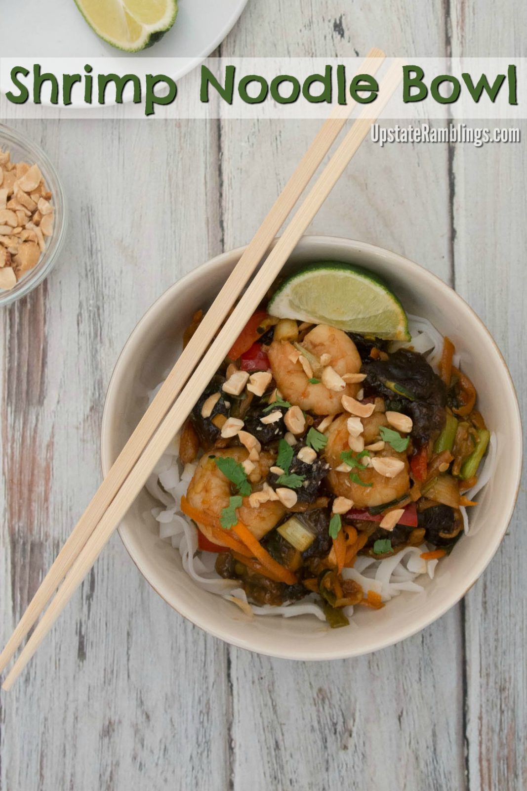 Shrimp noodle bowl with vegetables and chopsticks.