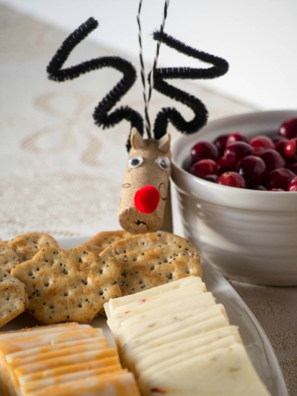 A plate of cheese and crackers with a reindeer on it.
