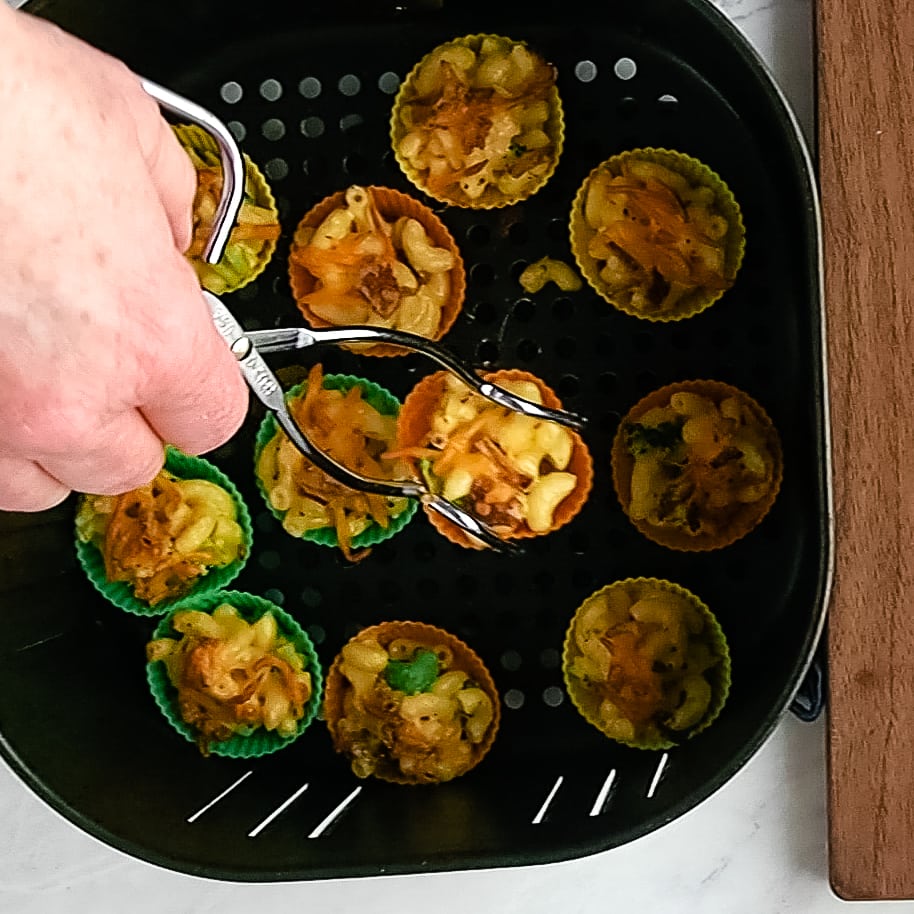 using tongs to take mac and cheese bites out of air fryer basket
