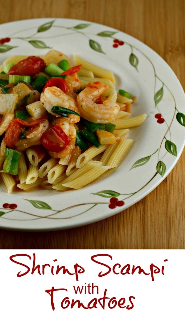 Shrimp scampi with tomatoes on a plate.
