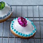 Easter cookies with icing and sprinkles on a cooling rack - Figolli Cookies