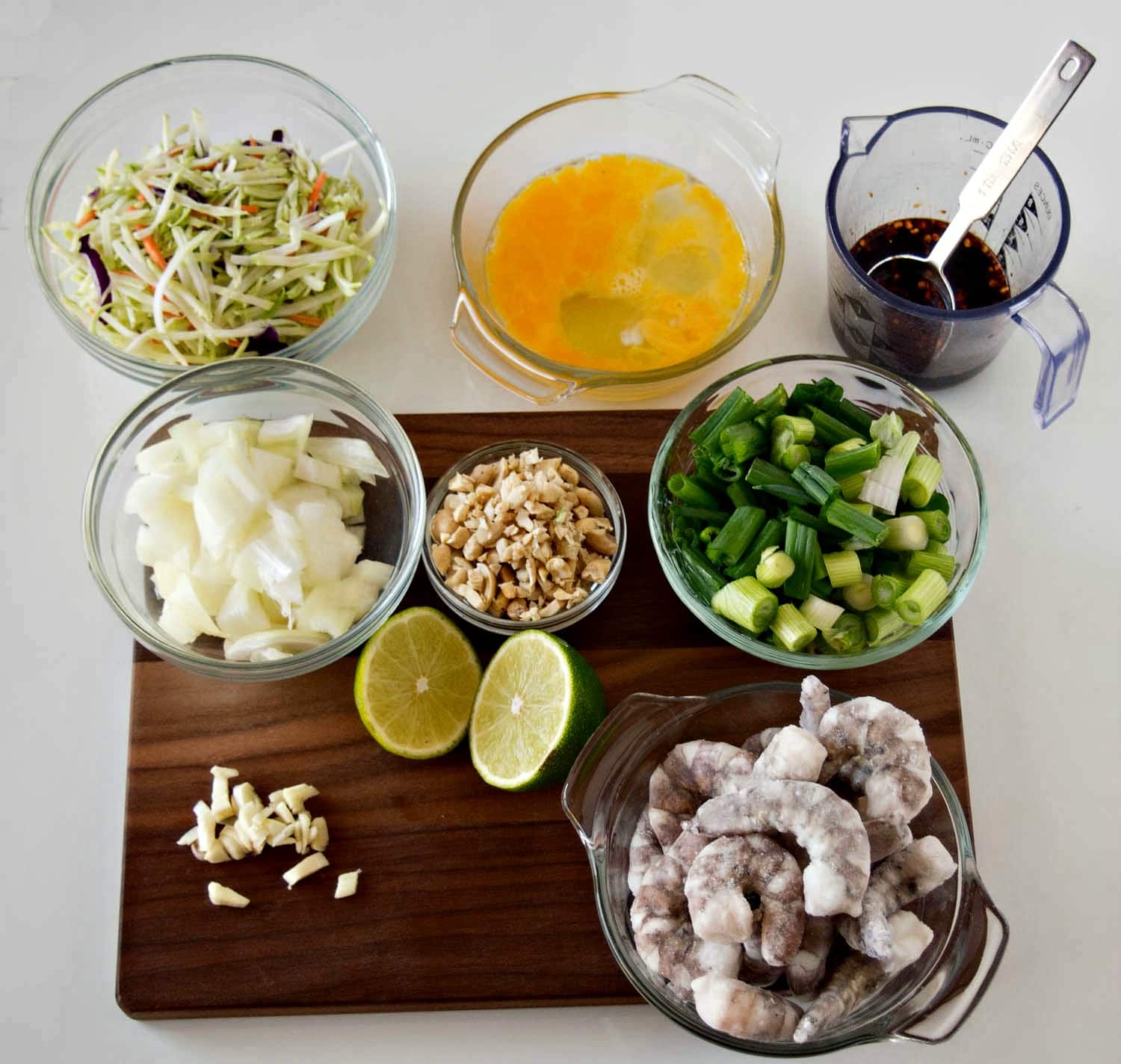 The ingredients for thai fried rice on a cutting board.