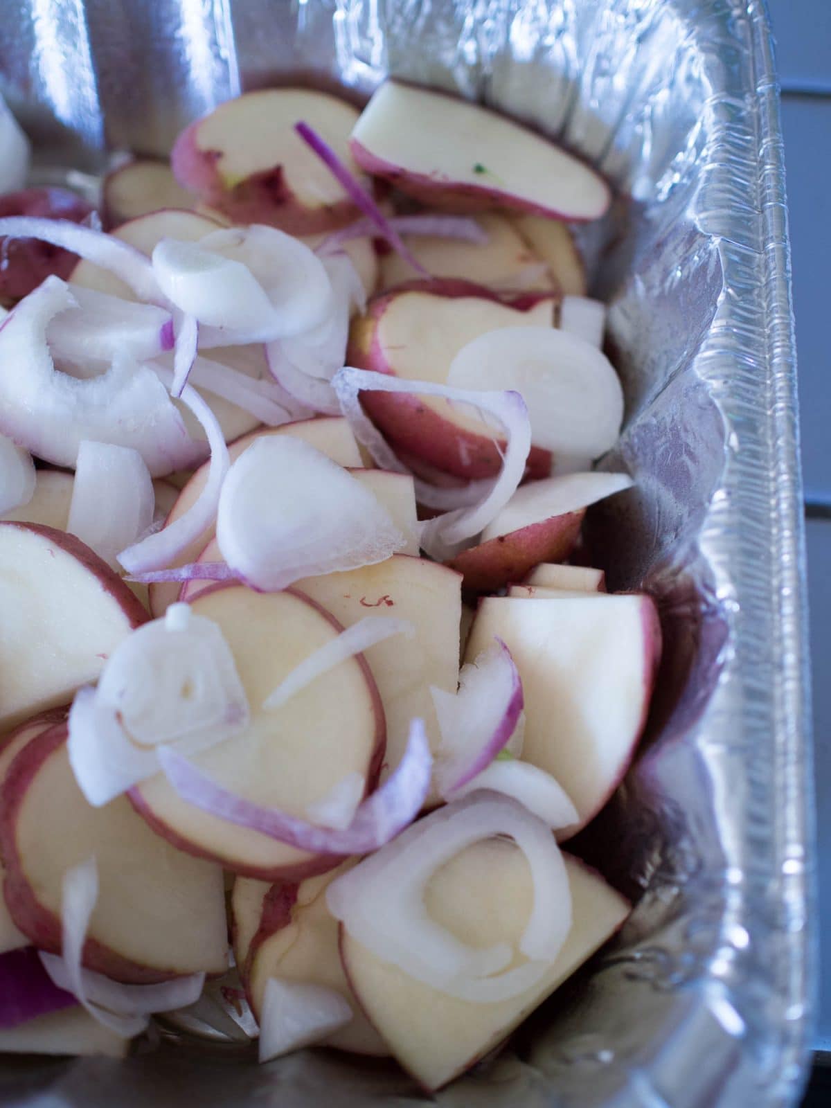 Potatoes mixed with onions on the grill