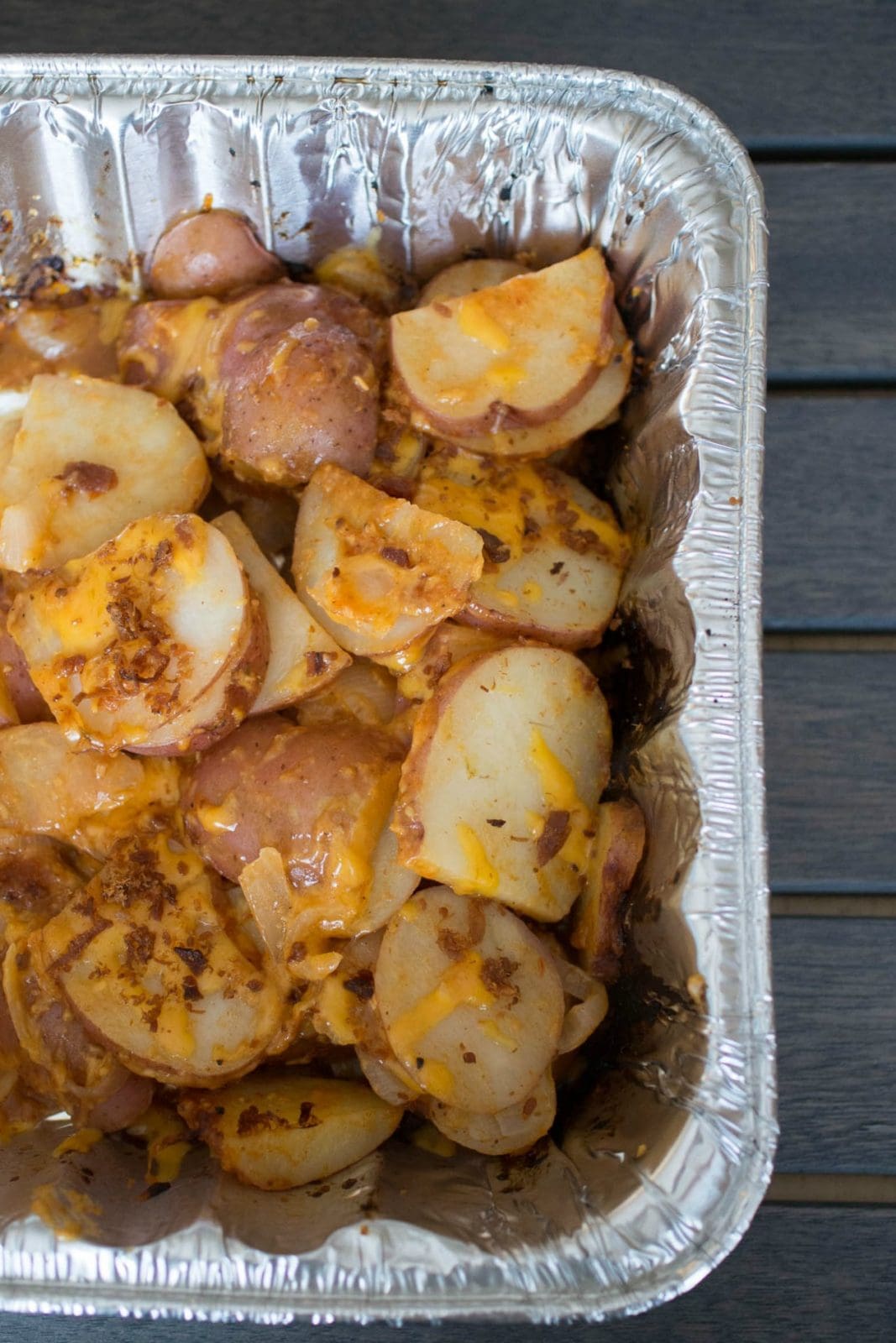 grilled potatoes in foil roasting pan after cooking on the grill