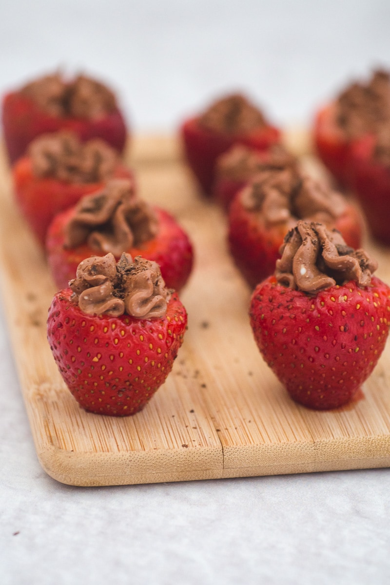 These chocolate cheesecake stuffed strawberries are made from fresh berries filled with chocolate cream cheese and sprinkled with grated chocolate. This is a simple no-bake treat that is easy to make and delicious - excellent for parties, Valentine's Day or an anniversary. #strawberries #cheesecake #ValentinesDay