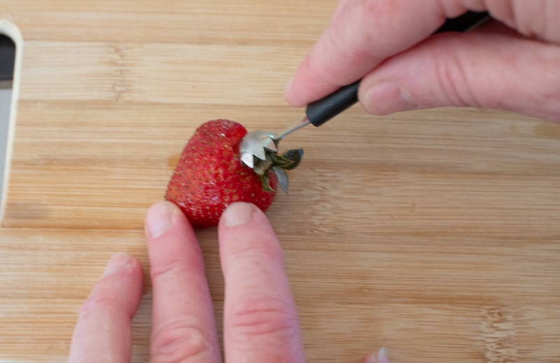 Using a strawberry huller on a strawberry