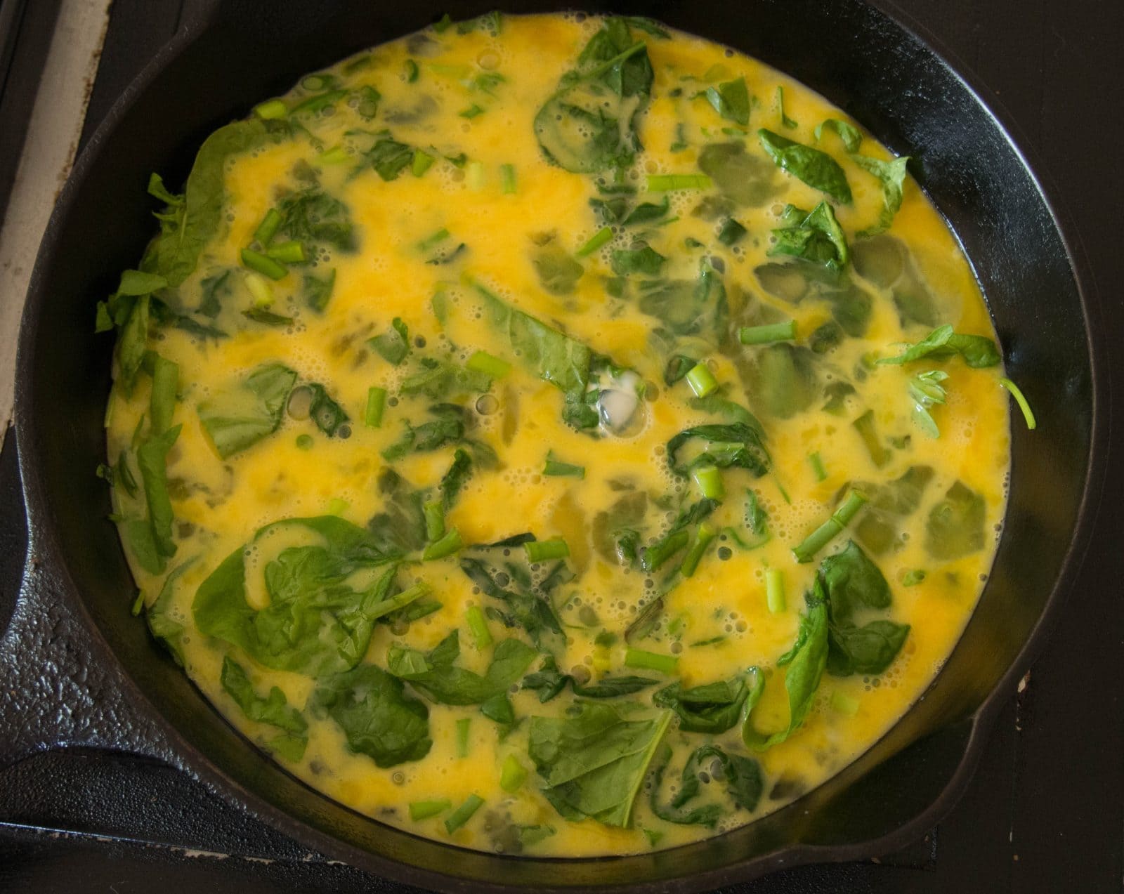 Cooking the eggs for a spinach frittata 