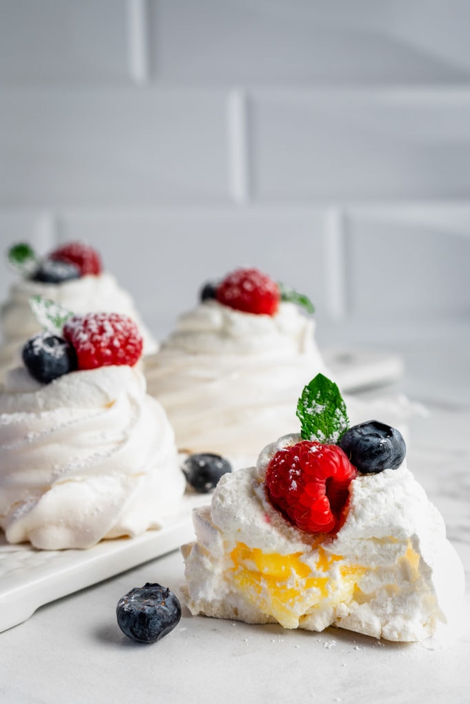 pavlova on a cutting board with berries