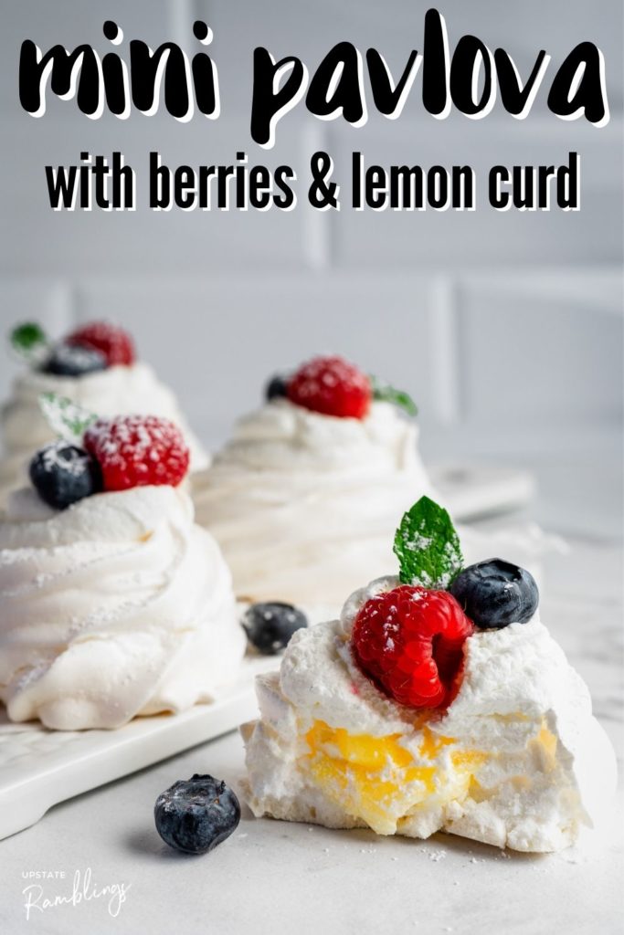 summer berry pavlova cut open to show lemon curd